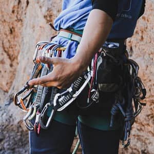 a photo of a person with a lot of climbing equipment