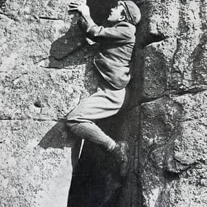 an old photo of a person climbing from 1890